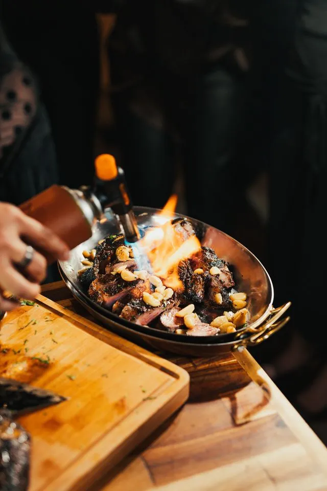 Chef preparing a dish with a blowtorch