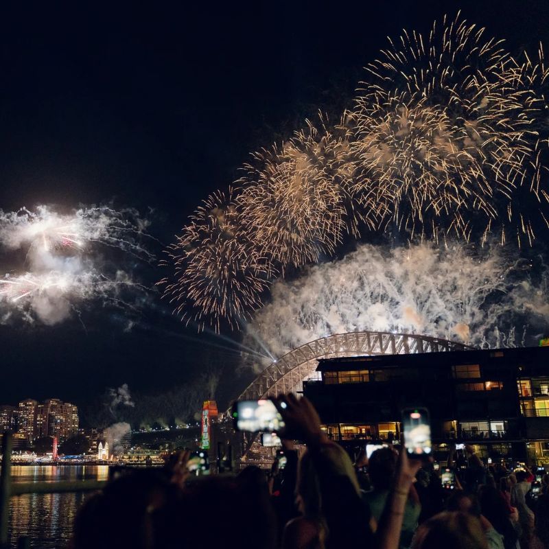 Guests filming the New Year's Eve fireworks over the Harbour Bridge from the water at Elements Bar and Grill